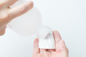 putting lotion on cotton round