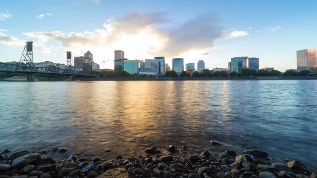 Ultra high definition 4k time lapse movie of moving clouds over downtown city of Portland Oregon with Hawthorne bridge along Willamette River at sunset 4096x2304