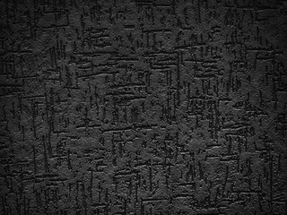 Detail of a textured, black exterior wall