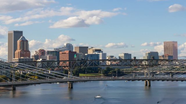 Ultra high definition 4k time lapse of moving clouds and freeway auto traffic over downtown city of Portland Oregon and Tilikum Crossing along Willamette River 4096x2304