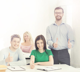 Fototapeta premium Group of teenage students and a teacher at the lesson