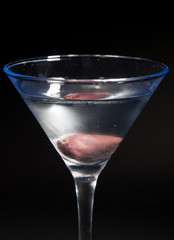 Martini cocktail isolated on black background. Vertical shot, cl