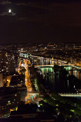 Fototapeta na wymiar View from the Eiffel Tower at night. River and bridges in the fr