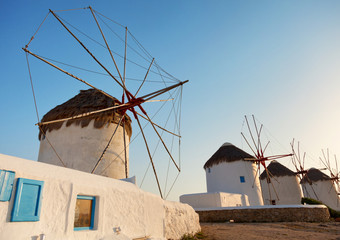 Row of four windmills shot at sunset in Mykonos island, Greece