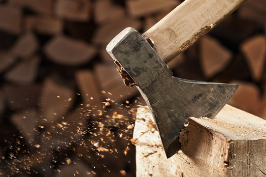 Axe cutting wood block