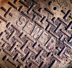 old rusted street sewer cover