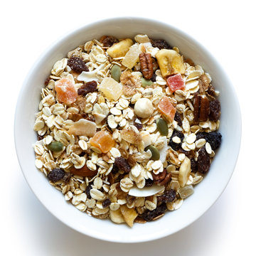 Breakfast Bowl Of Fruit And Nut Muesli Isolated On White From Above.