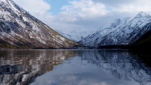 Lower Multinskoe lake in the Altai Mountains at late Autumn with snow on mountains, Siberia, Russia.