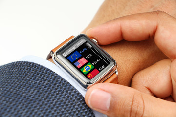 Businessman checking exchange currency through a smart watch app