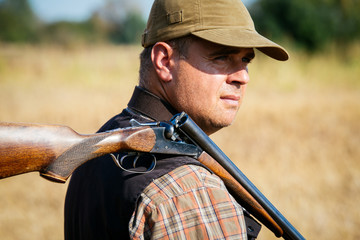 Hunter With Open Shotgun On Shoulder