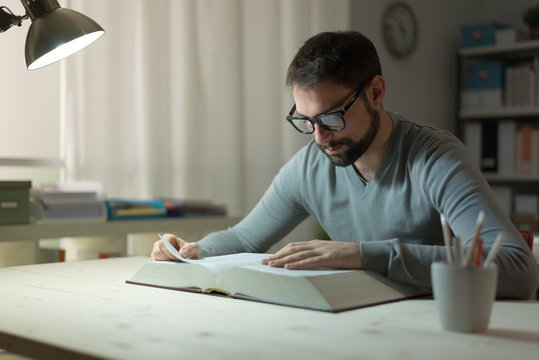 Smart Man Studying At Night