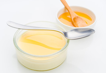 custard with honey in small glass jar isolated
