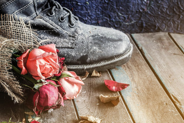 Wilted roses on old wood.