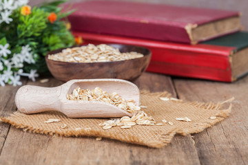 Fototapeta na wymiar oats in spoon on wood table