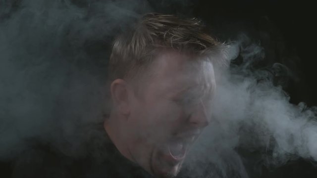 Smoke in mans face