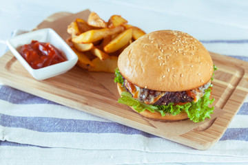 burger and french fries on wooden table