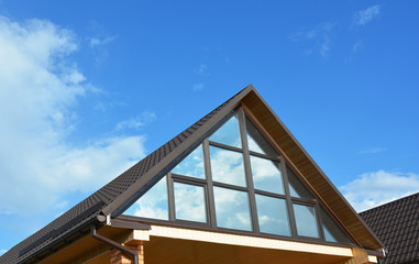 Modern house with metal roofing, panoramic window, skylight, roof window 