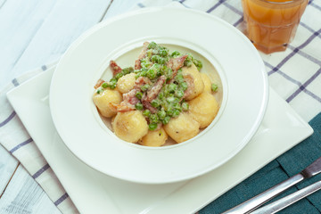 Potato dumplings with fried onion and bacon