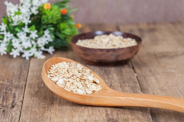 oats in spoon on wood table
