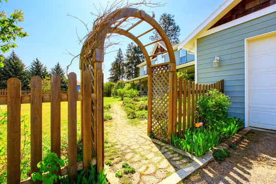 View of Wooden arbor. Arched entry to the garden.