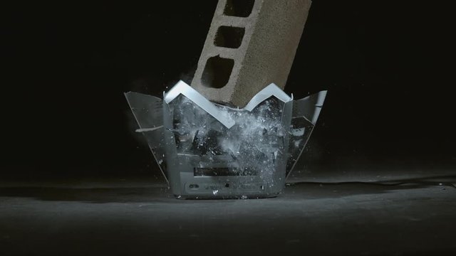 Concrete block is dropped on television in slow motion; shot on Phantom Flex 4K at 1000 fps