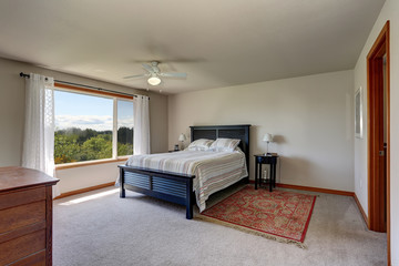 Bedroom interior with beige walls, rug and white curtains