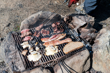Barbecue with meat, mushrooms and bread