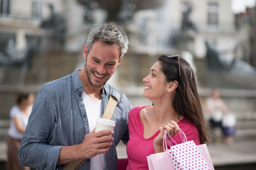  A cheerful tourist couple visiting a city during their trip