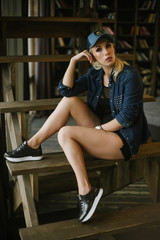 blond girl in a baseball cap.