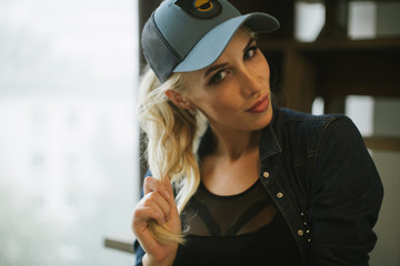 blond girl in a baseball cap.