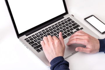 Unrecognizable man using a modern portable computer on an white table
