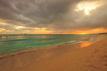 Twilight at Waikiki beach in Oahu. Waikiki beach is a beautiful place to enjoy the sunset over the ocean. Waikiki in South Shore, is the neighborhood of Honolulu and the most popular beach of Hawai.