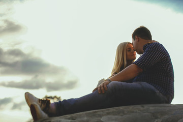 Young beautiful couple in jeans and shirts for a walk in the mou