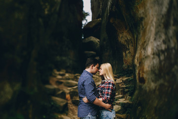 Young beautiful couple in jeans and shirts for a walk in the mou