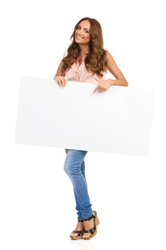 Beautiful Girl Holding White Poster And Pointing