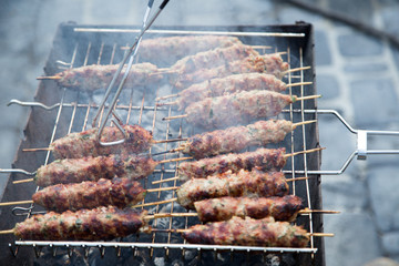 Cooking of lula kebab on the grill at picnic