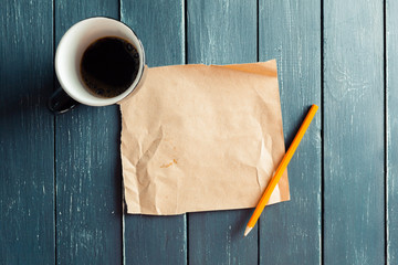 crumpled sheet of paper and pencil