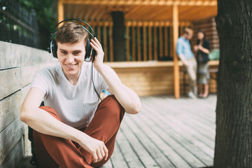 Young man with headphones outdoors.
