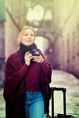 Fototapeta premium Young woman looking and taking pictures outdoors