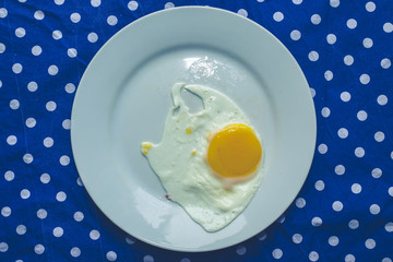 single fried egg on polka dot trendy background, minimal style design