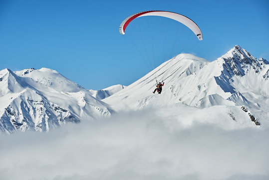 A Man Flying On A Paraglider In The Mountains Of Georgia