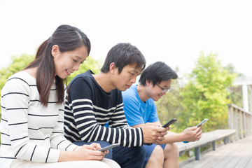 people stake smart phone together