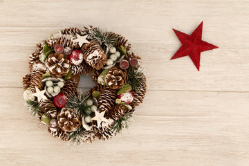 Delicate Christmas wreath of pine cones and a red star