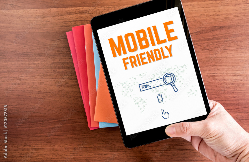 Poster top view of hand holding tablet with mobile friendly word and ic