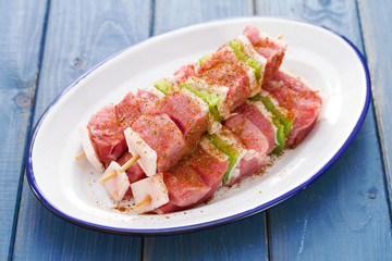 meat in sauce on dish on wooden background