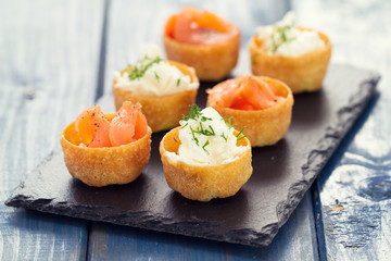 appetizer salmon with fresh cheese on board