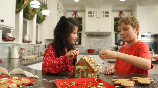 Decorating gingerbread house for Christmas