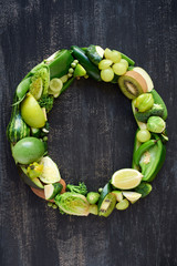 Green hued collection of  green produce shaped to letters of alp
