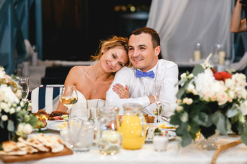 Young beautiful stylish smiling newlyweds