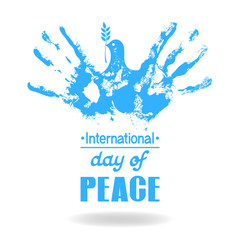 Two hand prints made a silhouette of a flying dove of peace with an olive branch. Concept for International peace day.